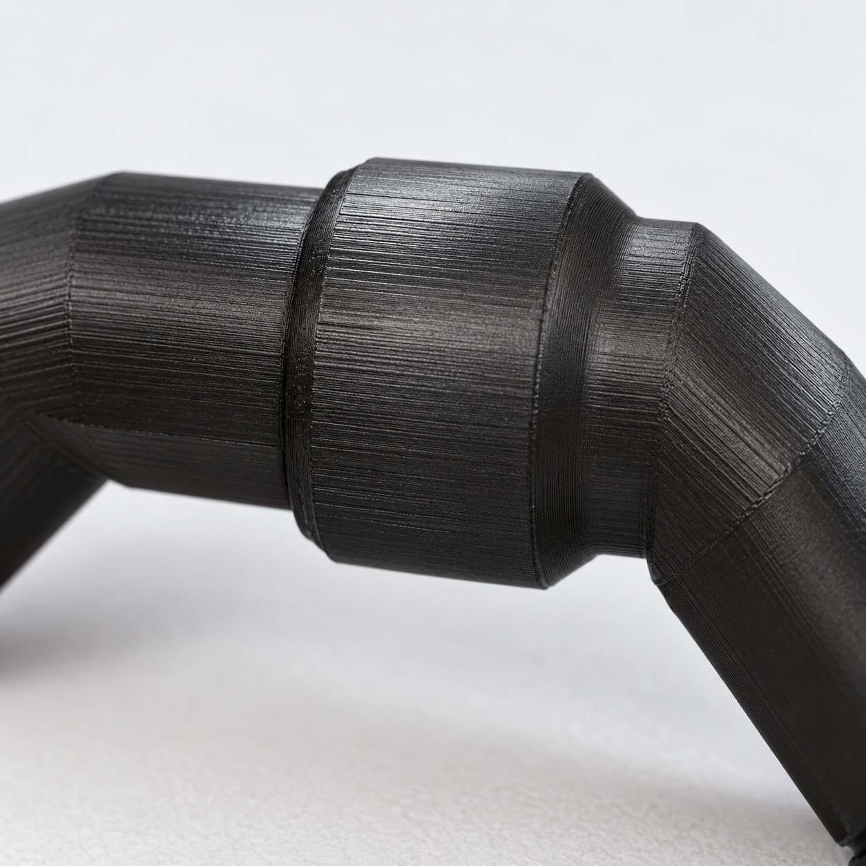 Eheim 12/16mm to 1/2 Inch Vinyl Barb Elbow Adapter, 90 Degree, Black, close up of the printed surface