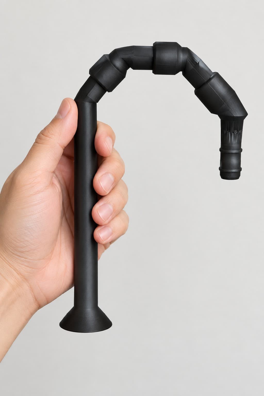 Lily Pipe Outflow Single, Eheim 12/16mm, Replacement, Black, held in a hand to show its size