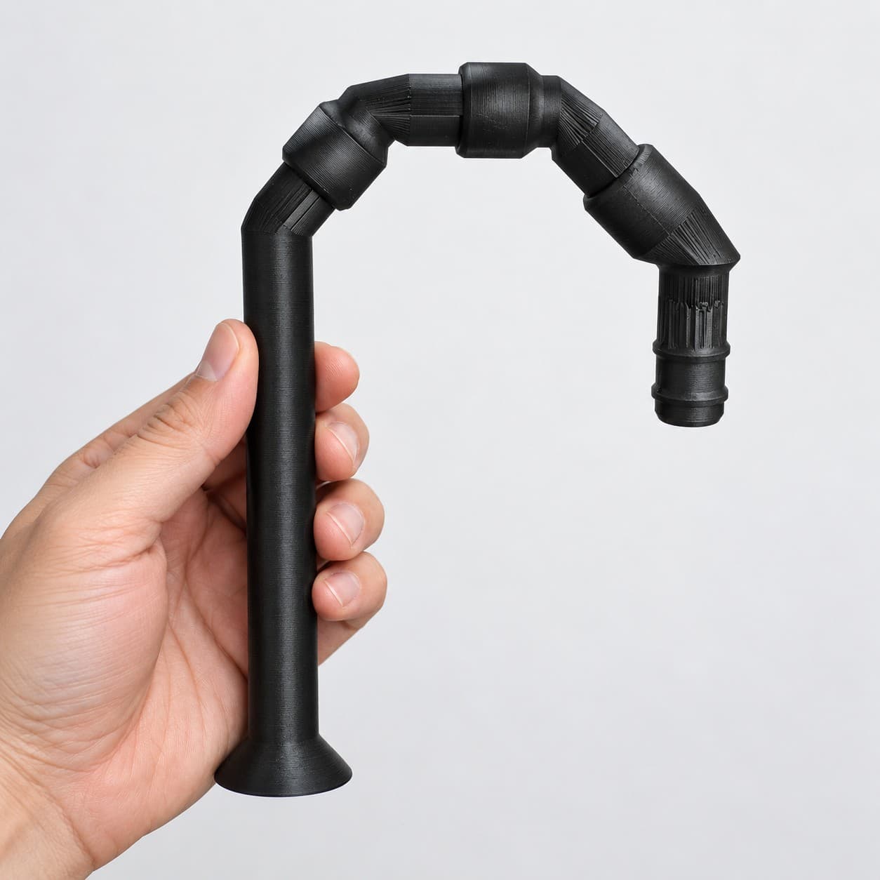 Lily Pipe Outflow Single, Eheim 16/22mm, Replacement, Black, held in a hand to show its size