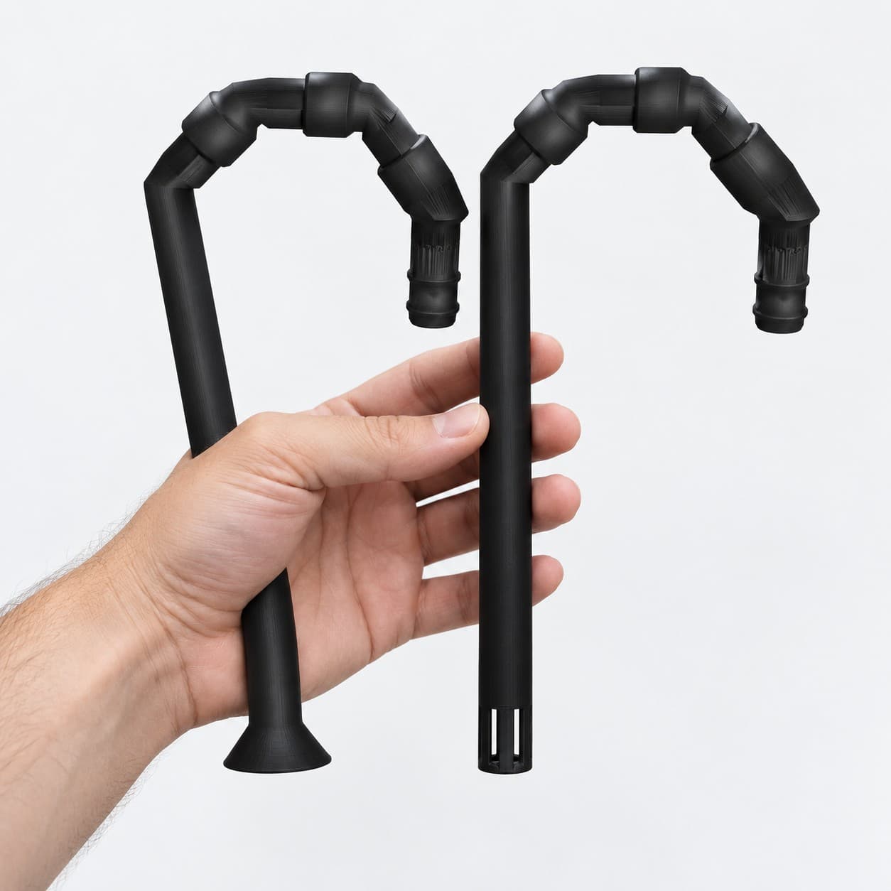 Lily Pipe Inflow + Outflow Pair, Eheim 16/22mm, Black, held in a hand to show its size