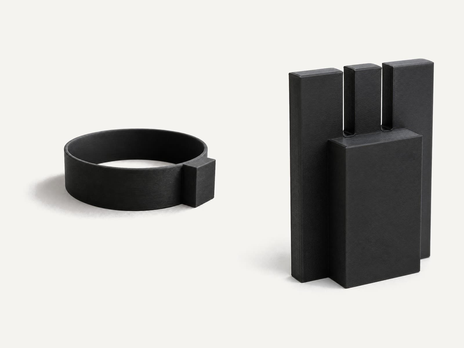 The parts of the Reef Feeding Station Kit, side by side, in black.
